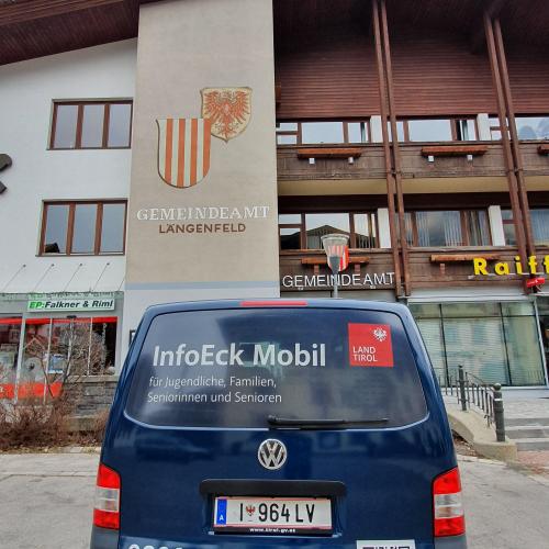 Das Bild zeigt die Rückseite des InfoEck Mobil vor der Gemeinde Längenfeld im Ötztal.
