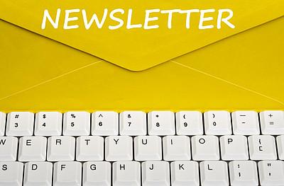 Ein gelber Kuvert mit der Aufschrift Newsletter, darunter sieht man eine PC Tastatur.